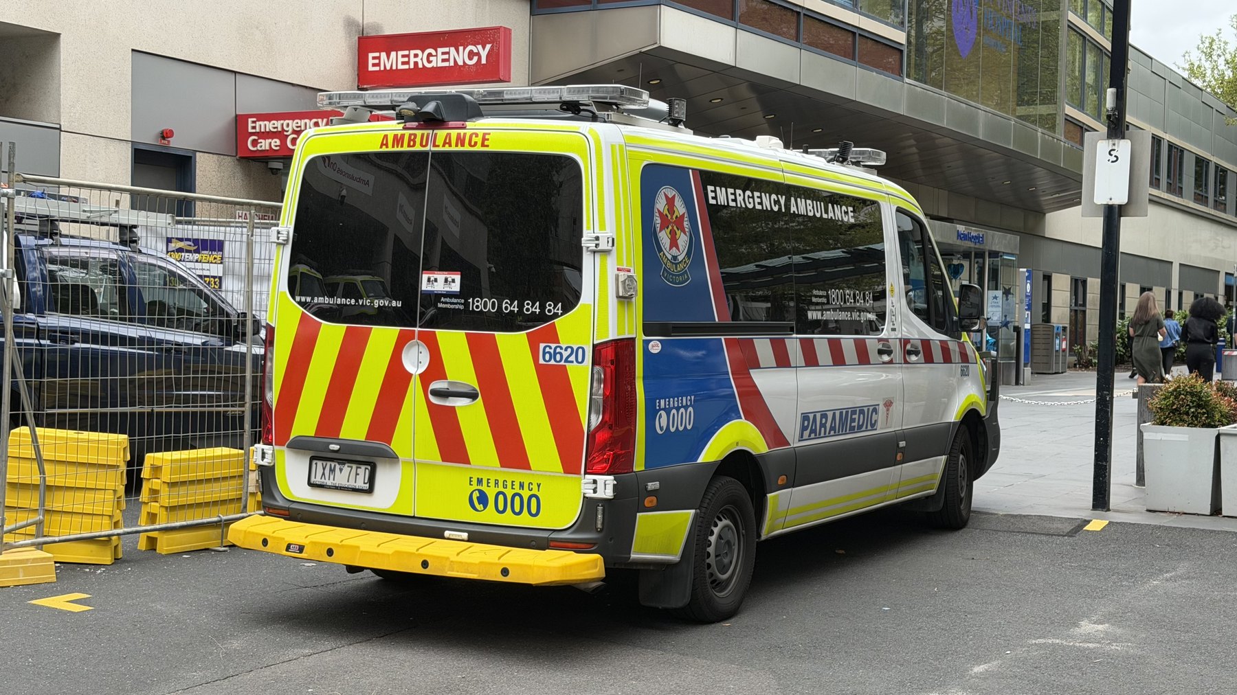 Emergency ambulance parked outside a hospital emergency entrance.